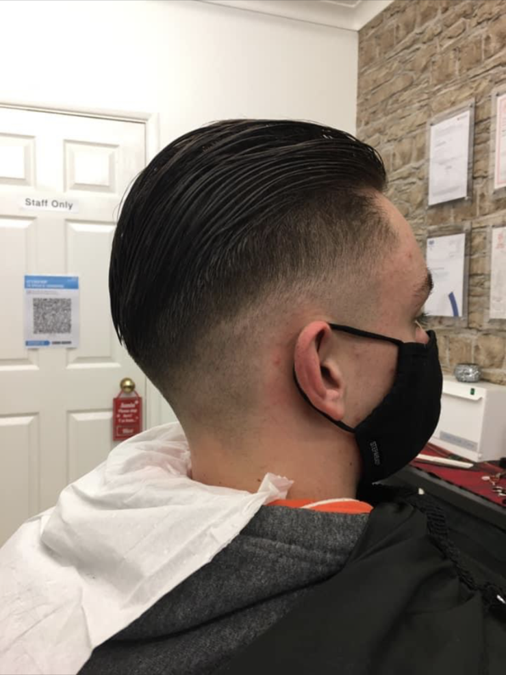 A slicked-back cut with a fade